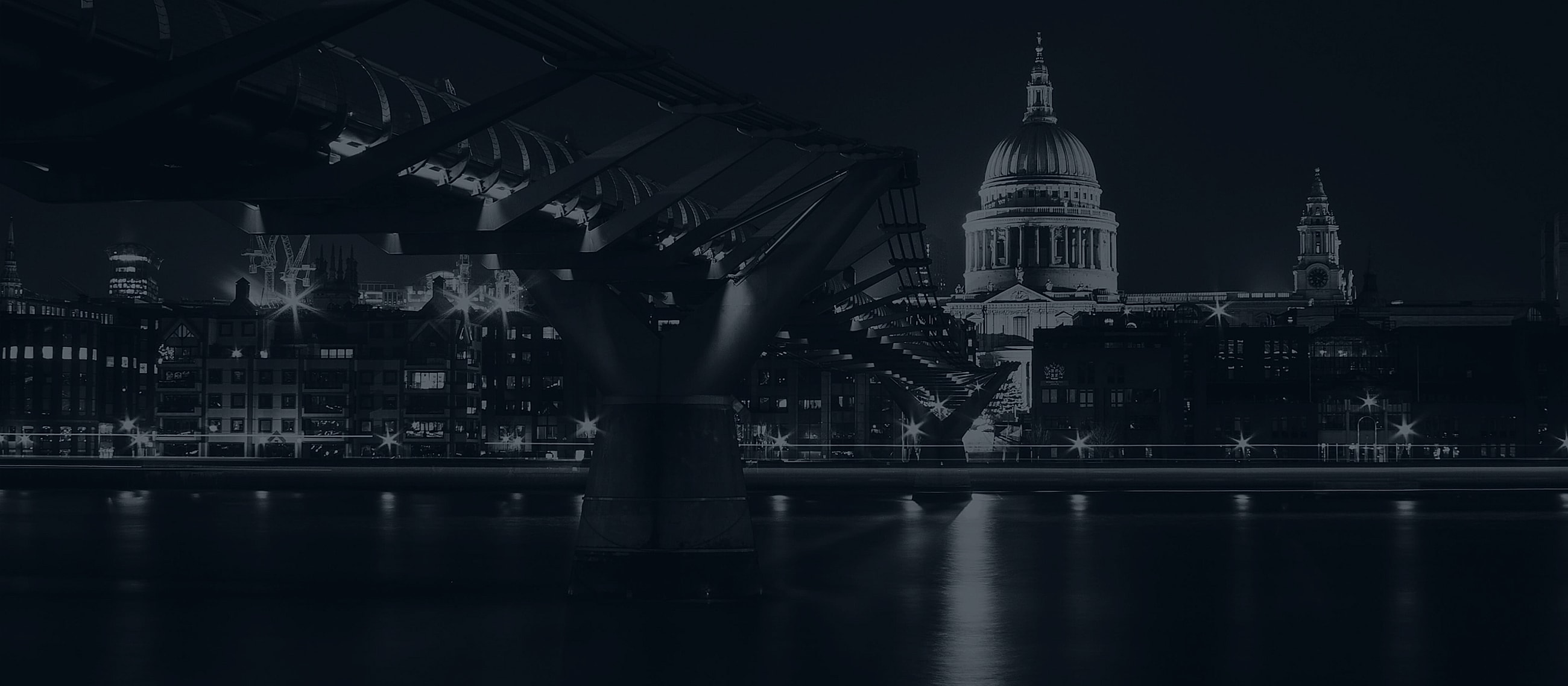 London skyline at night with illuminated buildings.