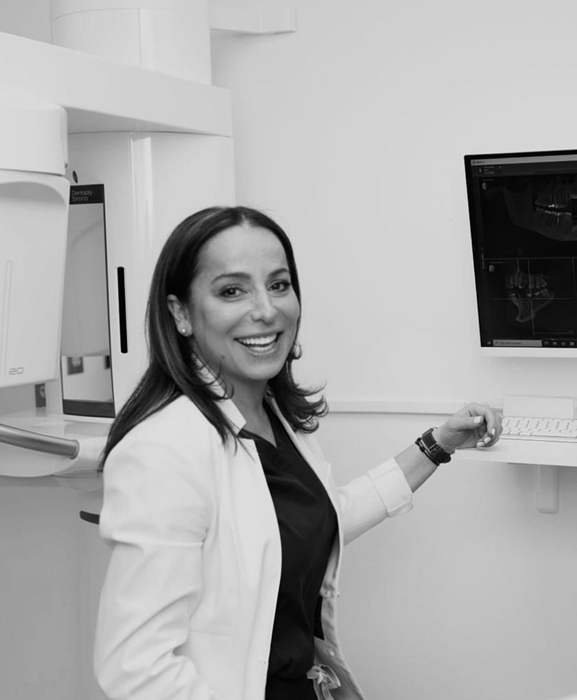 Smiling professional in a dental office setting.